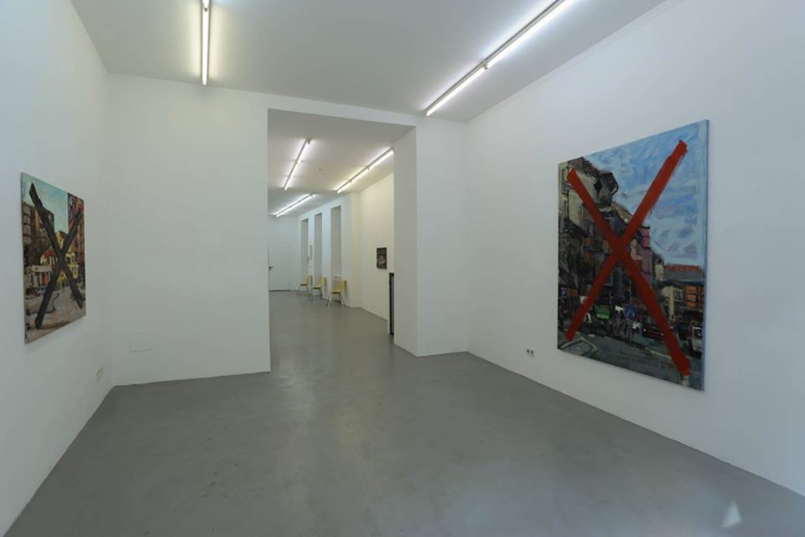 Secession-style paintings placed against pristine white walls